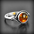 Jolie bague en argent orné d'un cabochon arrondi d'ambre cognac (h:10mm).