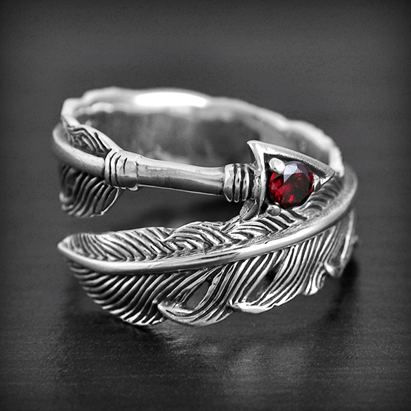 Très jolie bague d'une flèche en argent, pointe ornée d'un zirconium et plume de belle finition....