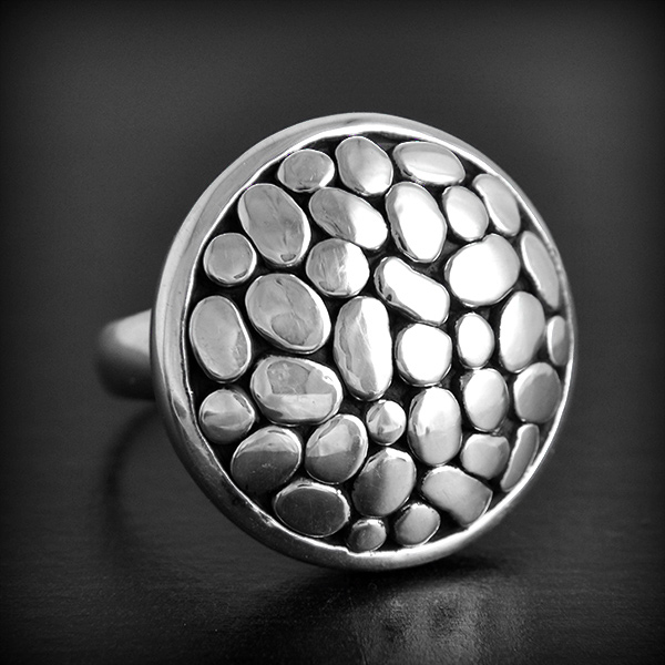 Bague en argent ronde légèrement bombée décorée de petits galets argent C'est un modèle creux et...