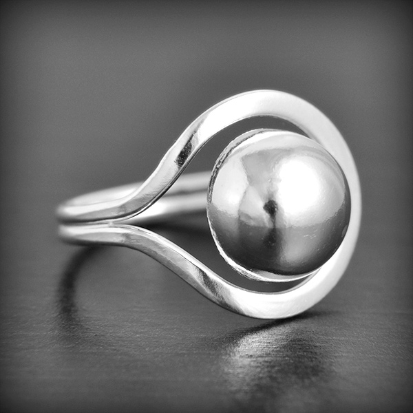 Bague en argent  de forme originale d'une boule entourée d'un fil argent plat, modèle légèrement...