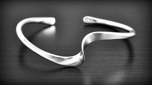 Beau bracelet rigide en argent en forme d'un ruban tourné avec une ondulation (l:16mm, ep:3mm).