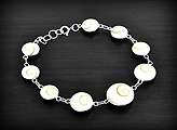 Superbe bracelet en argent mont&eacute; de coquillages Oeil de Sainte Lucie de plus en plus gros vers le...