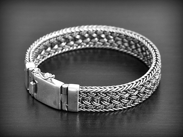 Très beau bracelet en argent tressé artisanal, maille plate, fermoir sécurité (ep:12mm. L: 19,5cm).