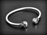 Bracelet esclave rigide en argent, tube creux pour plus de confort  avec deux crânes ronds en...