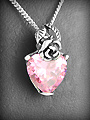 Magnifique pendentif en argent d'un zirconium facetté en forme de cur, surmonté d'une rose,...