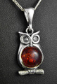 Pendentif en argent d'un bel hibou dont le corps est fait d'une perle d'ambre couleur cognac...