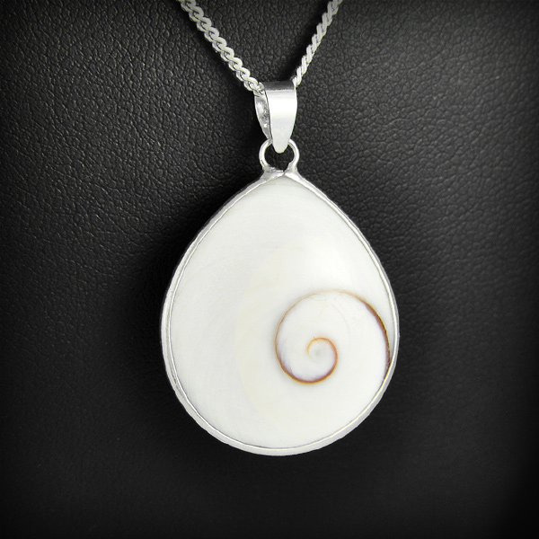 Pendentif d'un coquillage "oeil de Sainte Lucie" cerclé en argent laissant le coquillage...